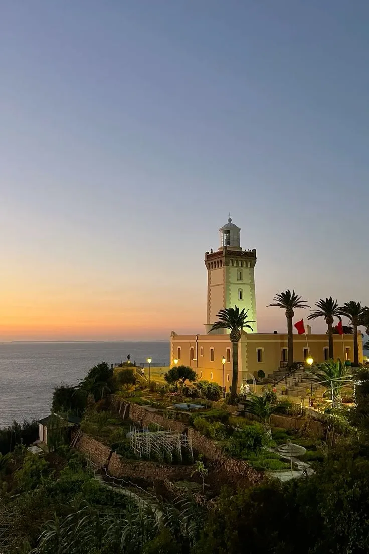 Cap Spartel lighthouse with palm trees at sunset near Tangier
