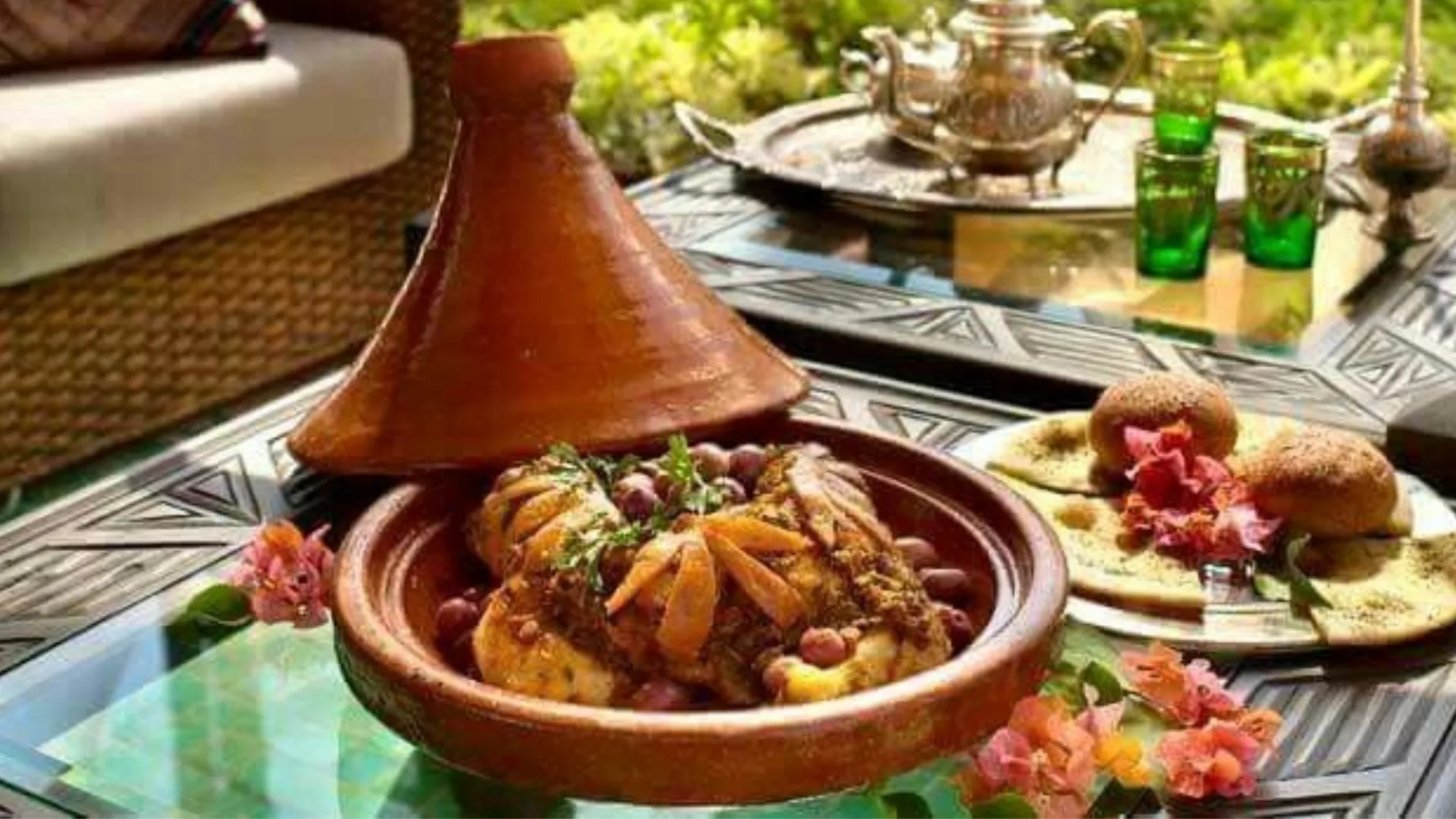 Chicken tagine and Moroccan dishes served on a restaurant table in Marrakech