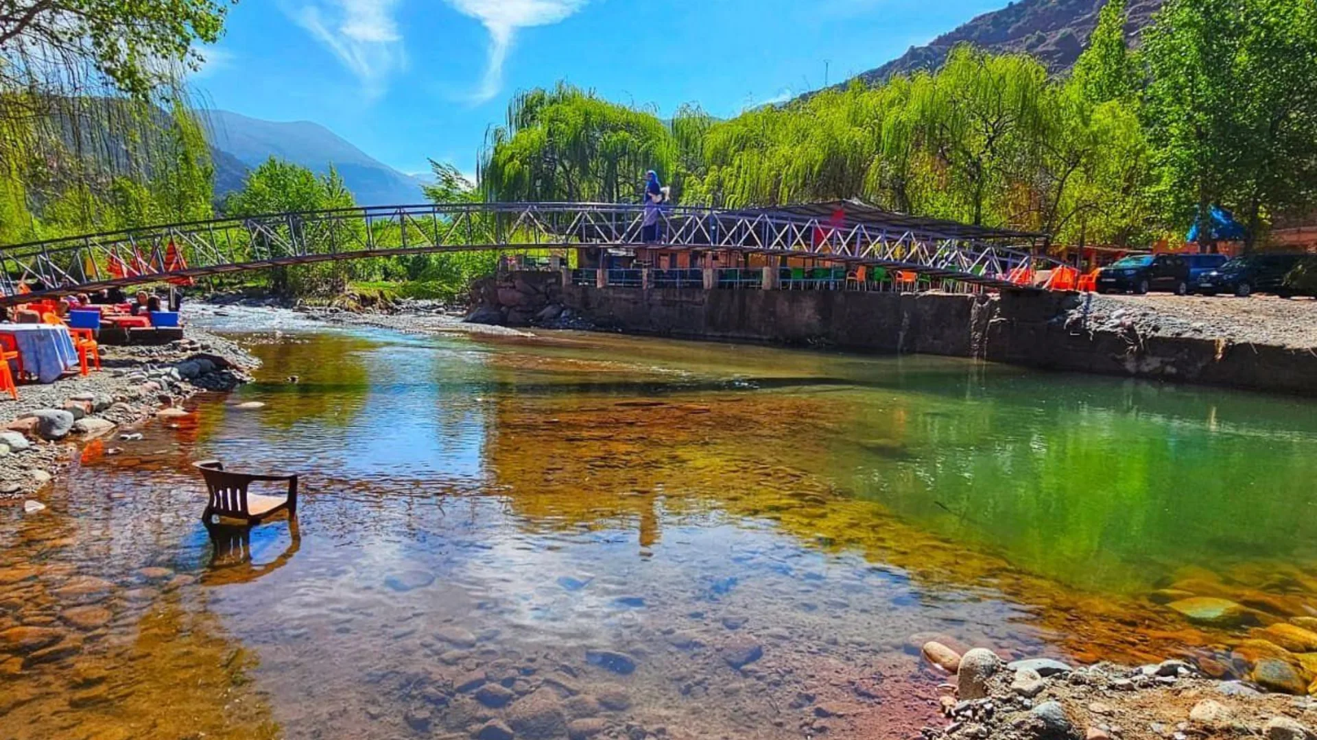 Clear river and footbridge among green trees in the Ourika Valley near Marrakech