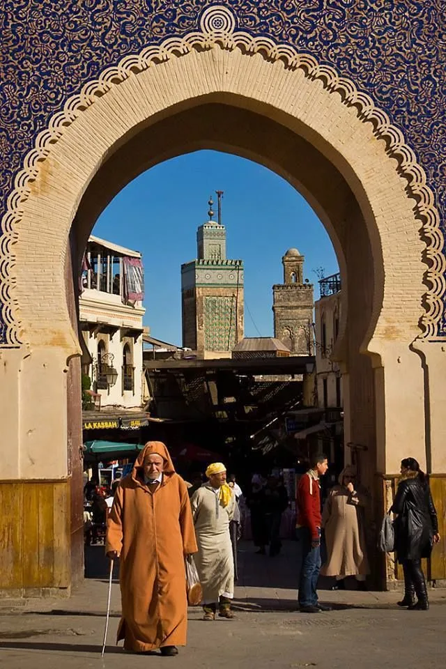 Fes medina minarets seen through an ornate arched doorway