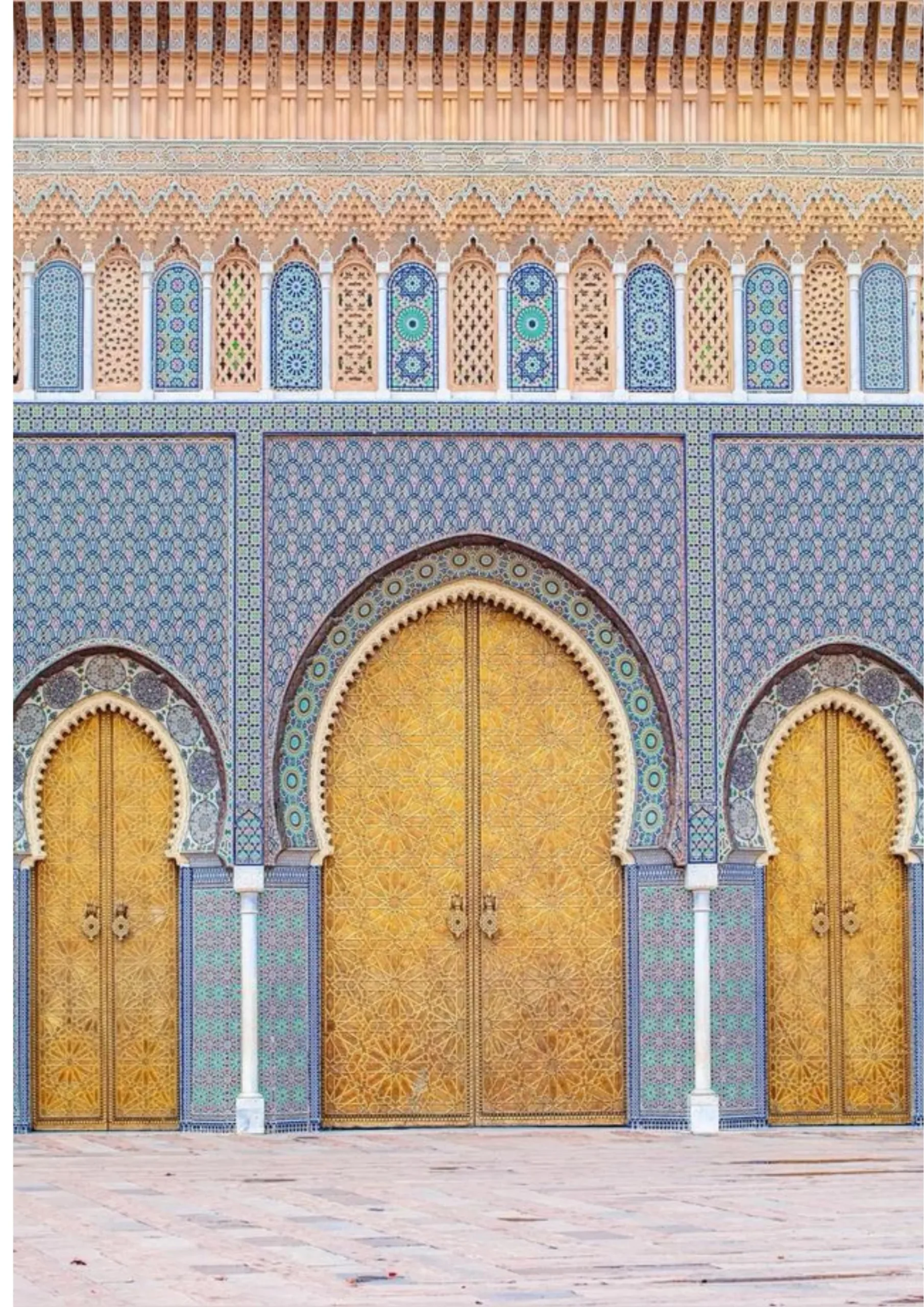 Golden brass gates of the Royal Palace in Fes with blue and white tilework