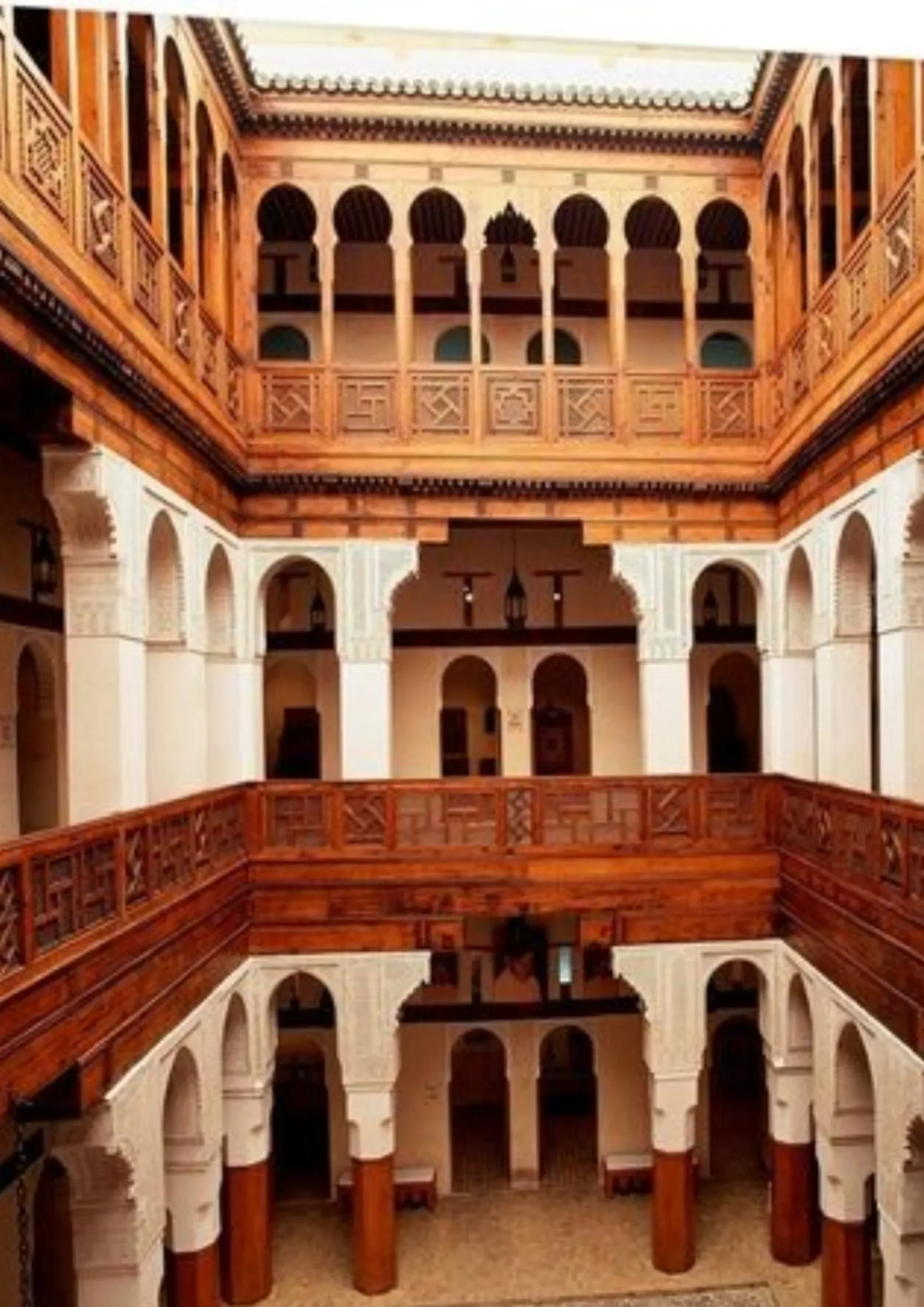 Interior courtyard of a madrasa with carved wooden galleries in Fes