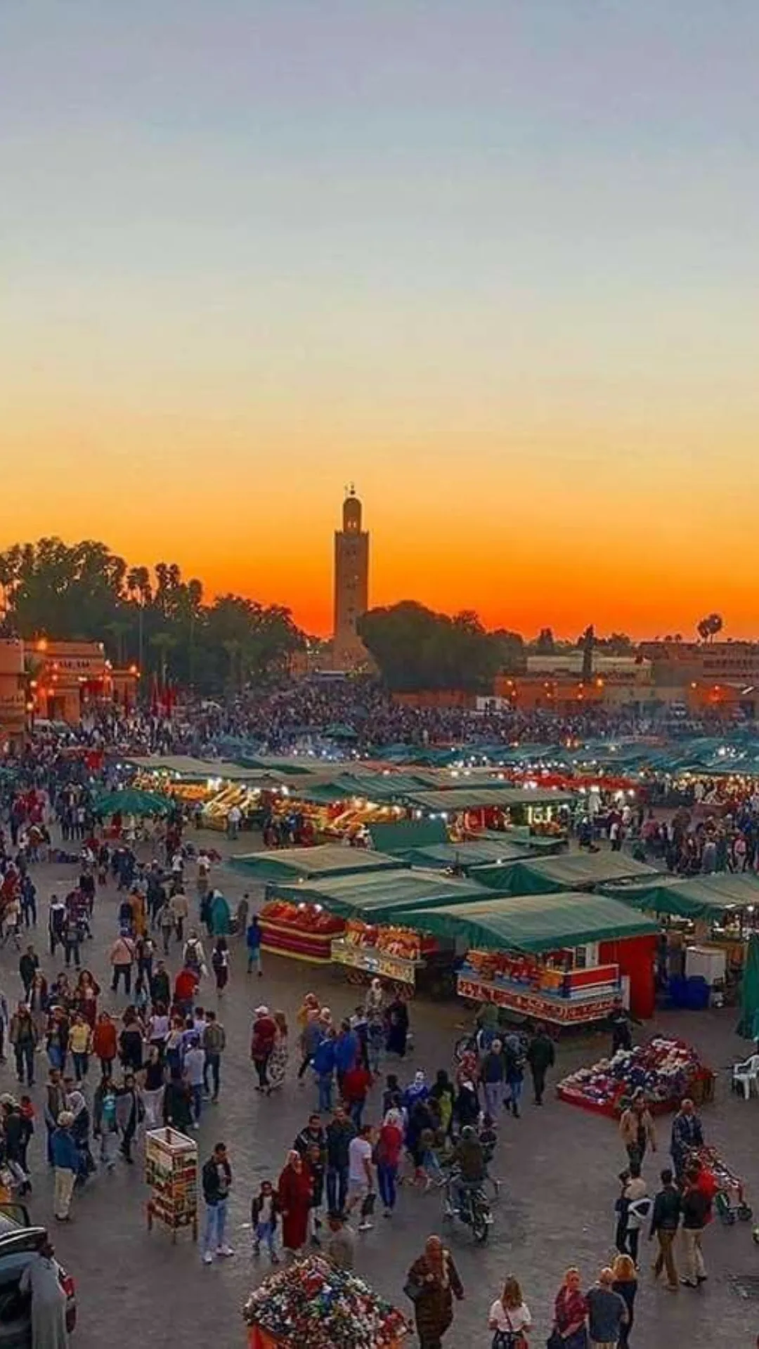 Jemaa el-Fna square at dusk with the Koutoubia minaret in Marrakech