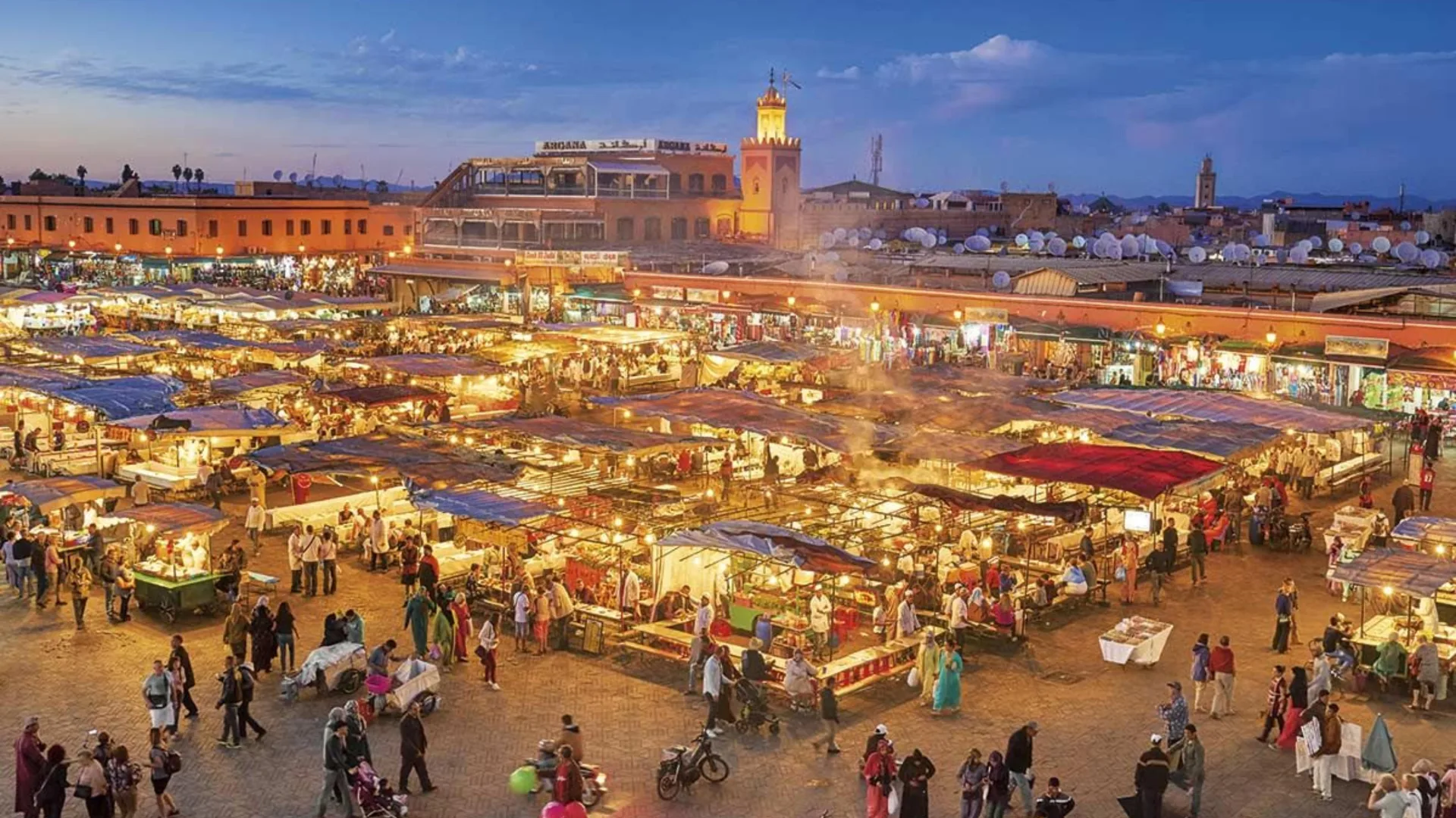Jemaa el-Fna square in Marrakech at dusk with food stalls and crowds
