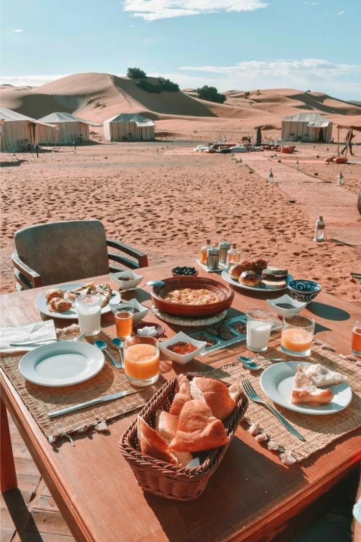 Zagora desert breakfast at sunrise Moroccan breakfast table set on the sand at a Zagora desert camp