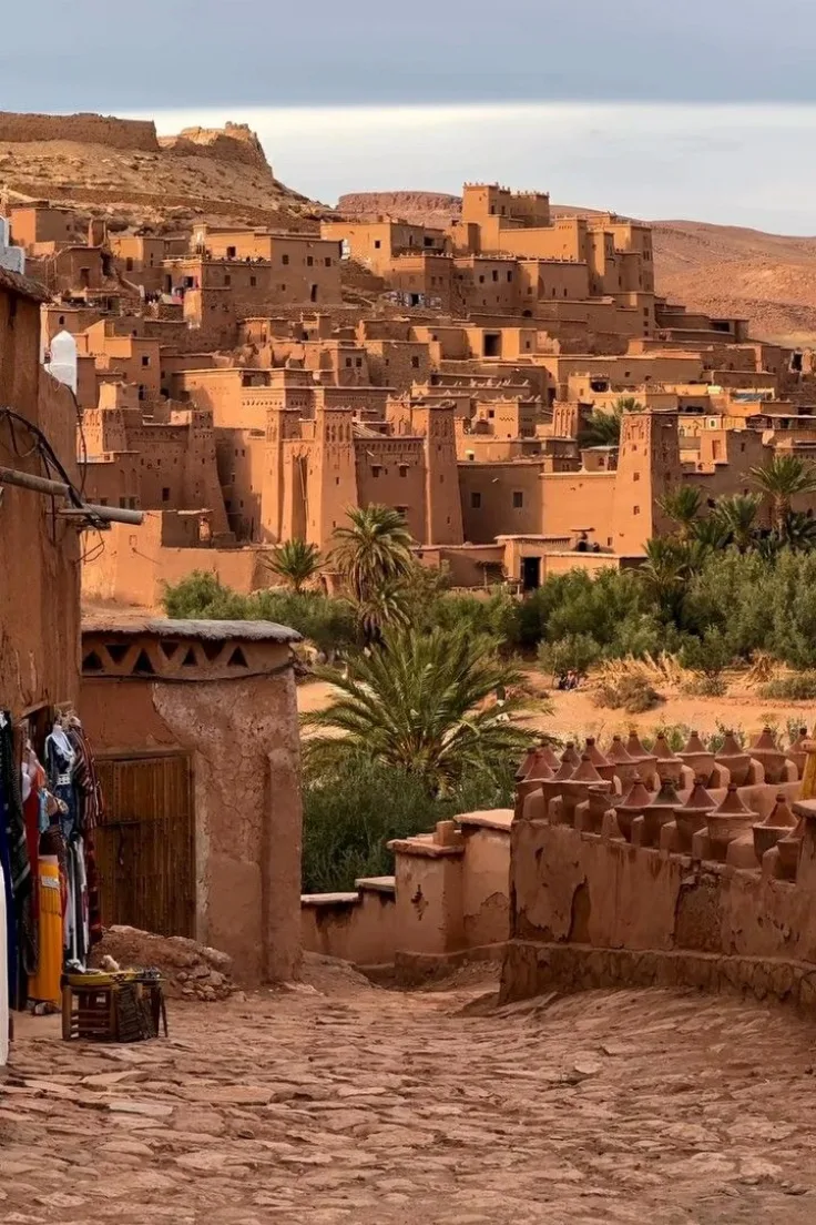Red clay kasbah and palm trees in southern Morocco on the Marrakech to Zagora route