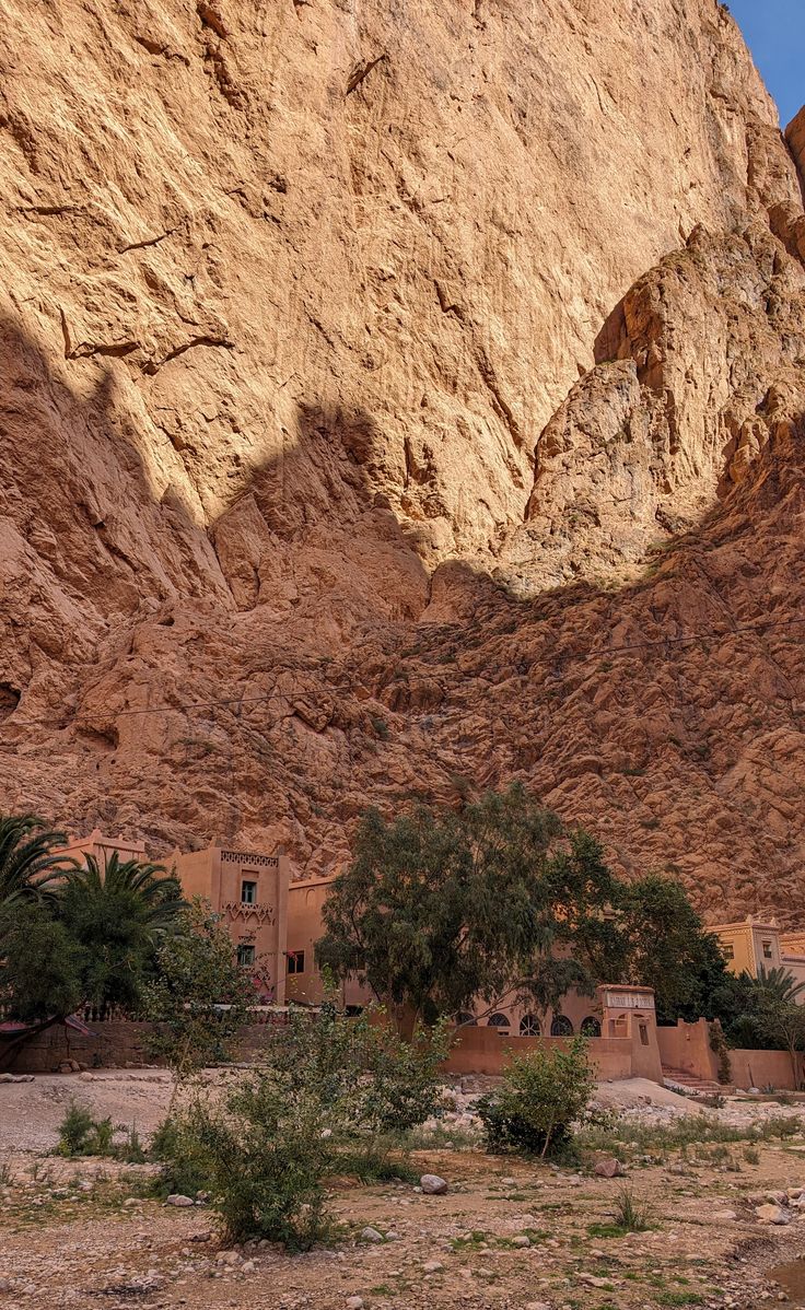 Todra Gorge canyon walls with a local man in a blue robe