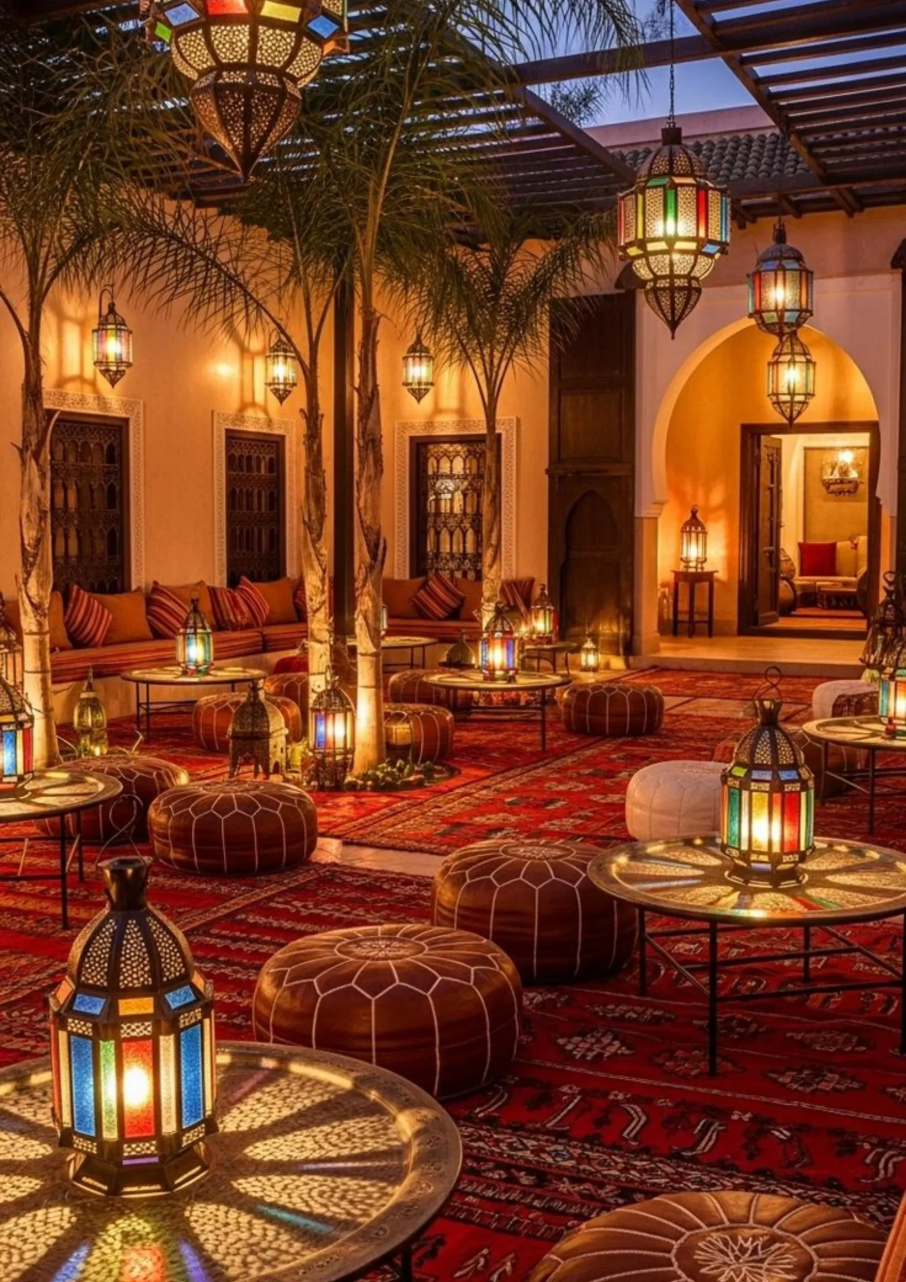 Traditional Moroccan riad lounge with lanterns and rugs in Fes