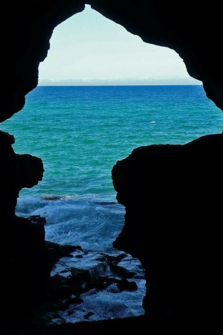 Turquoise sea seen through the rock opening of the Caves of Hercules near Tangier